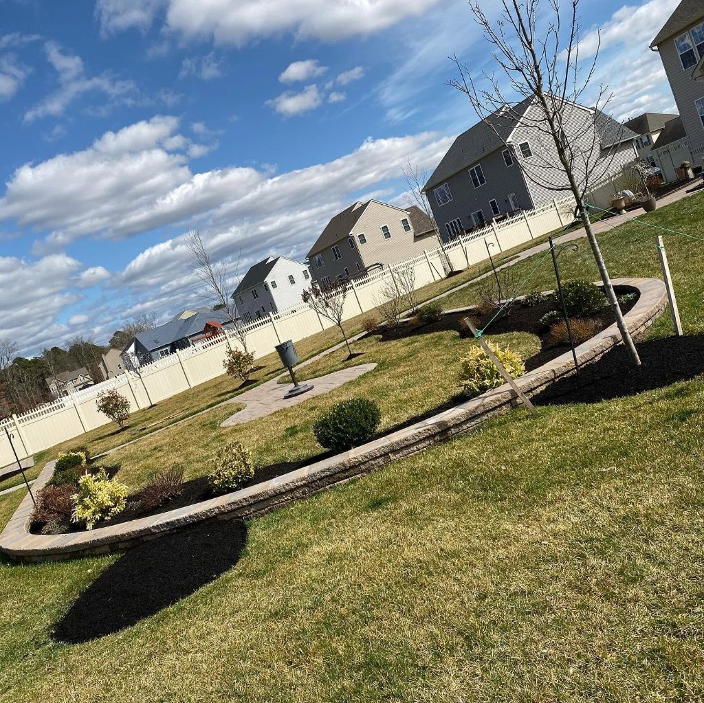 Custom landscape design — curved garden beds with trees, shrubs and paver path South Jersey