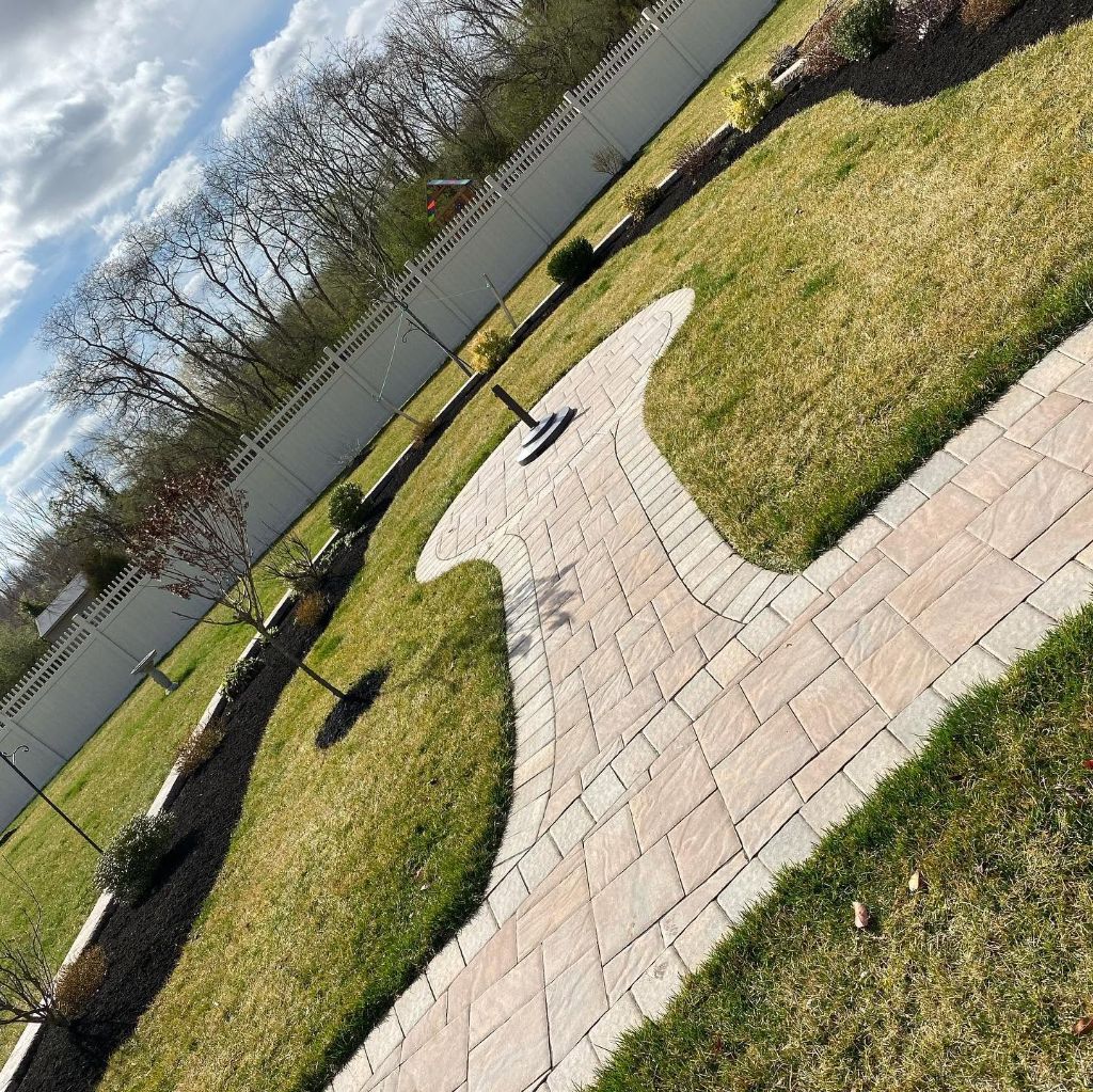Stamped paver walkway curving through lawn South Jersey